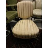 A late Victorian rosewood framed and upholstered nursing chair with upholstered back and seat on