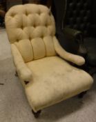 A Victorian buttoned upholstered low slung open arm salon chair on turned front legs to castors,