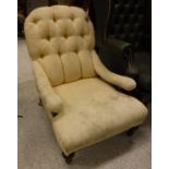 A Victorian buttoned upholstered low slung open arm salon chair on turned front legs to castors,