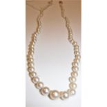 A graduated pearl single strand necklace with 18 carat white gold and platinum diamond mounted