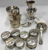 A collection of eight silver napkin rings (various styles, makers and dates),
