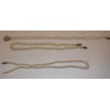 A two strand pearl necklace with pearl set flower head clasp, 34 cm long,