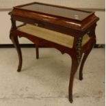 A modern kingwood bijouterie cabinet in the Louis XV taste with glass panelled caddy top over glass