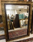 A pair of modern gilt framed rectangular wall mirrors with bevel edged plates 80 cm x 110.