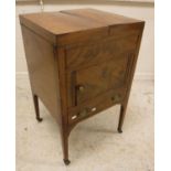 A 19th Century mahogany washstand, the double rising lid opening to reveal a bowl recess and mirror,