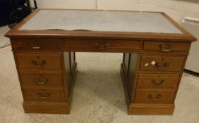 An early 20th Century walnut kneehole desk,