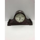 An early 20th Century mahogany cased dome top mantel clock with silvered dial and Arabic numerals