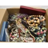 A box of assorted costume jewellery to include various beads, necklaces,