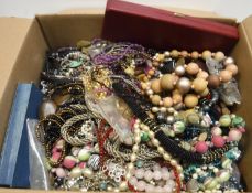 A box of assorted costume jewellery to include various beads, necklaces,