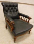 A Victorian buttoned upholstered walnut framed reclining armchair with galleried arm rails and