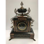 A late 19th Century French black and variegated rosso marble banded mantel clock,