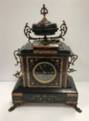 A late 19th Century French black and variegated rosso marble banded mantel clock,