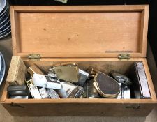 A crate and box of various vintage and modern cigarette lighters