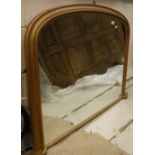 A modern gilt framed over mantel mirror of shallow domed form in the Victorian manner 109 cm wide x