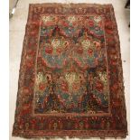 A Caucasian rug, the central panel set with floral design on a dark blue ground,