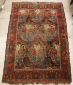 A Caucasian rug, the central panel set with floral design on a dark blue ground,