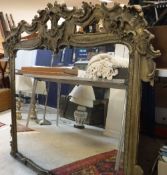 A Victorian giltwood and gesso framed over mantel mirror in the Rococo style with openwork