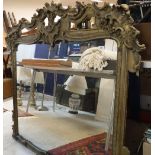 A Victorian giltwood and gesso framed over mantel mirror in the Rococo style with openwork