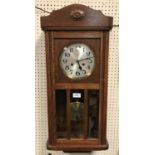 A 1930s oak cased drop dial wall clock,