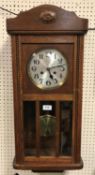 A 1930s oak cased drop dial wall clock,