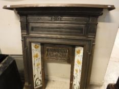 A late Victorian cast iron fire surround with art nouveau style tiles as stylised daffodils,