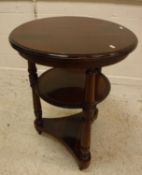 A mahogany occasional table of two circular tiers on turned supports,