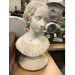A painted plaster bust of a young girl,