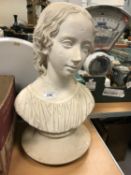 A painted plaster bust of a young girl,