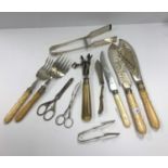 A small quantity of plated cutlery to include asparagus servers, bone handled anchovy tongs,