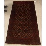 A Tekke Bokhara rug with all-over elephant foot medallions on a red ground,