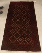 A Tekke Bokhara rug with all-over elephant foot medallions on a red ground,