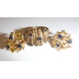 A 9 carat gold mounted bark effect ring set with six small sapphires, 5.