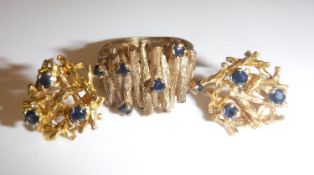 A 9 carat gold mounted bark effect ring set with six small sapphires, 5.