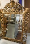 A 19th Century carved giltwood and gesso framed wall mirror in the Florentine manner with all over