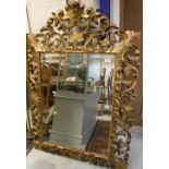 A 19th Century carved giltwood and gesso framed wall mirror in the Florentine manner with all over