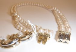 A pearl two strand necklace with bi-colour 9 carat gold clasp set with band of diamond chips, 37.