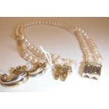 A pearl two strand necklace with bi-colour 9 carat gold clasp set with band of diamond chips, 37.