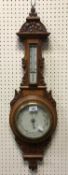 A circa 1900 carved oak framed aneroid barometer thermometer 78 cm high