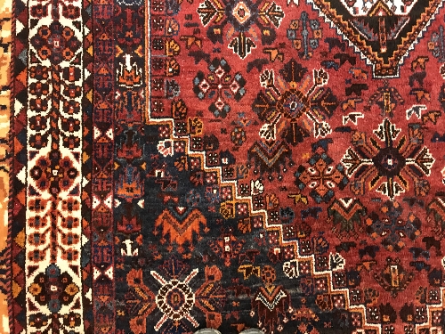 A Persian rug with centre lozenge medallion on a red ground, - Image 6 of 17