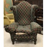 A circa 1900 upholstered wing back scroll armchair in the Flemish taste,
