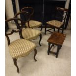 A set of three Victorian rosewood kidney back dining chairs with upholstered seats on cabriole