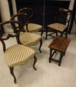 A set of three Victorian rosewood kidney back dining chairs with upholstered seats on cabriole