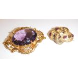 An amethyst and yellow metal mounted brooch/pendant the central cut stone 3 cm x 2.