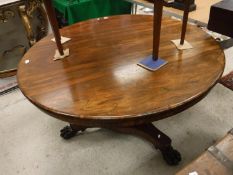 An early Victorian rosewood breakfast table, the circular snap top with plain frieze,