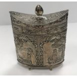 A circa 1900 Continental embossed silver lidded box of navette form with all-over figural panel