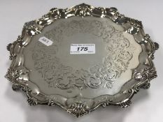 A Victorian silver salver with pie-crust edge and engraved decoration,