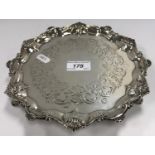 A Victorian silver salver with pie-crust edge and engraved decoration,