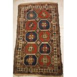 A Caucasian rug, the central panel set with repeating tiled decoration on a brown ground,