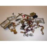 A collection of various costume jewellery to include filigree cross, various brooches,
