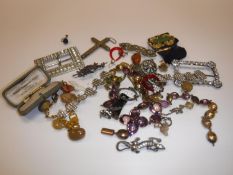 A collection of various costume jewellery to include filigree cross, various brooches,